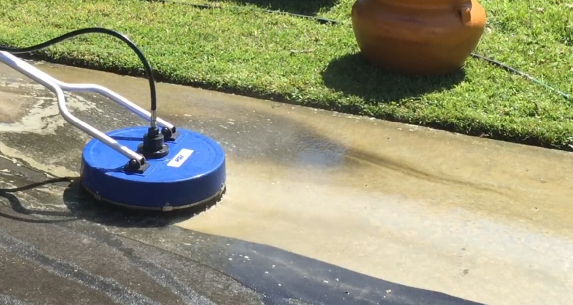 Whirley pressure cleaning tool removing dirt from a driveway.
