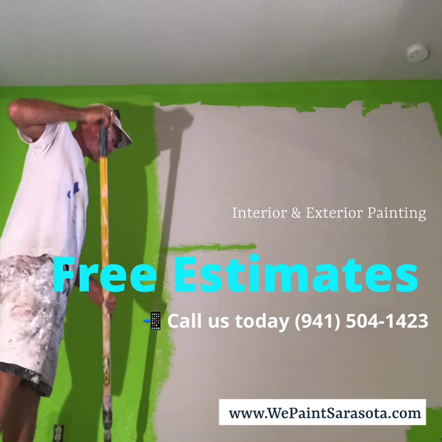 Painter covering a bright green interior wall with light paint
