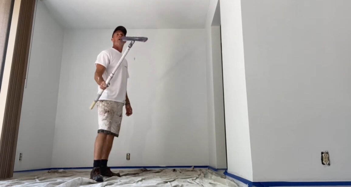 Extra White walls taking shape during painting with masking and drop cloths still in place